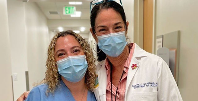 Dr. Sutherland and nurse wearing masks and smiling at the camera