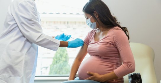 Pregnant woman getting a COVID booster shot