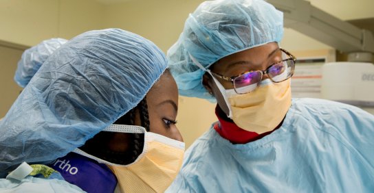 Two residents wearing surgical scrubs