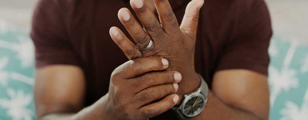 Image of man rubbing his hand