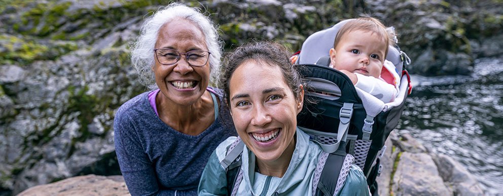 Two women hiking with a baby