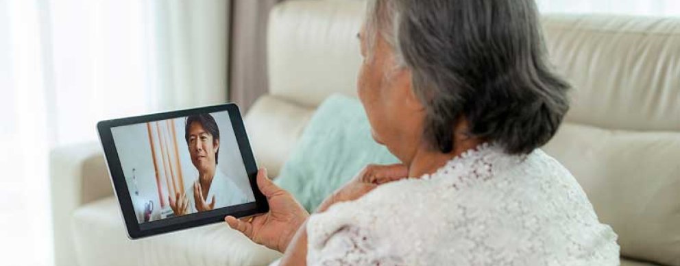 Image of woman looking at provider on tablet