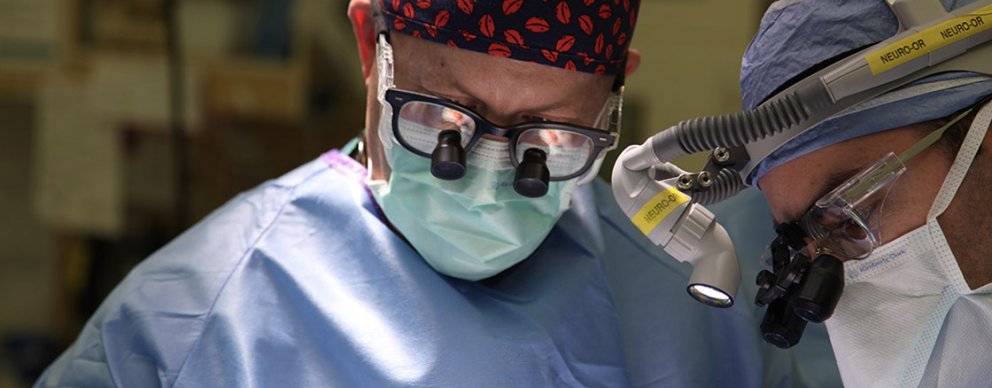 Two neurosurgeons preforming surgery